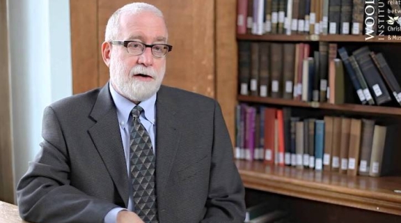 Fred Astren sitting in front of bookcase