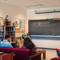 Two students lounging on the couch in the Jewish Studies Lounge